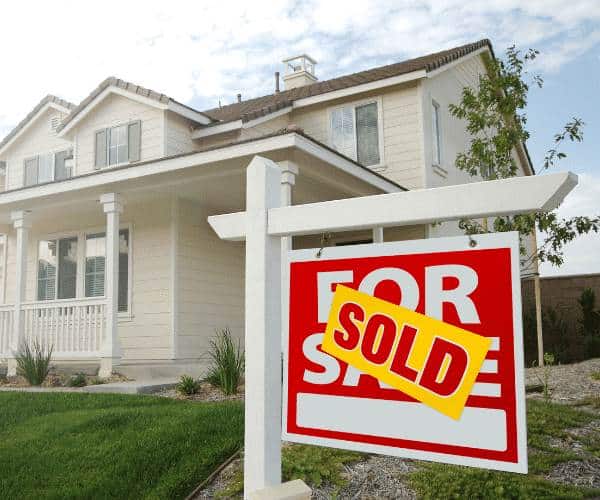 A home with for sale sign and Sold over sign