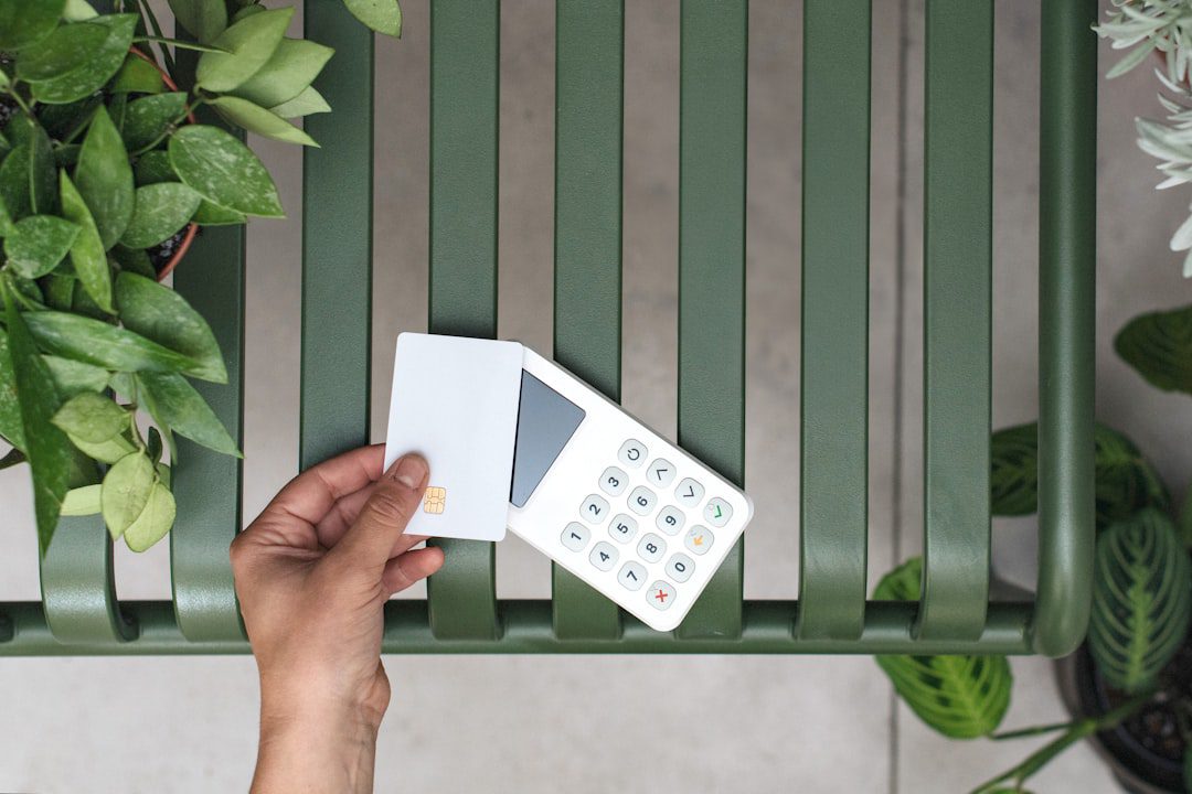 A top-down view of a clean, organized desk with a notebook, pen, calculator, and a small model of a house, representing home financing and planning.