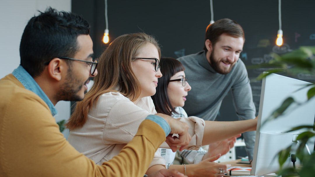 A diverse team of real estate professionals collaborating in a bright, modern office, representing a high-investment, team-based approach to marketing a home.