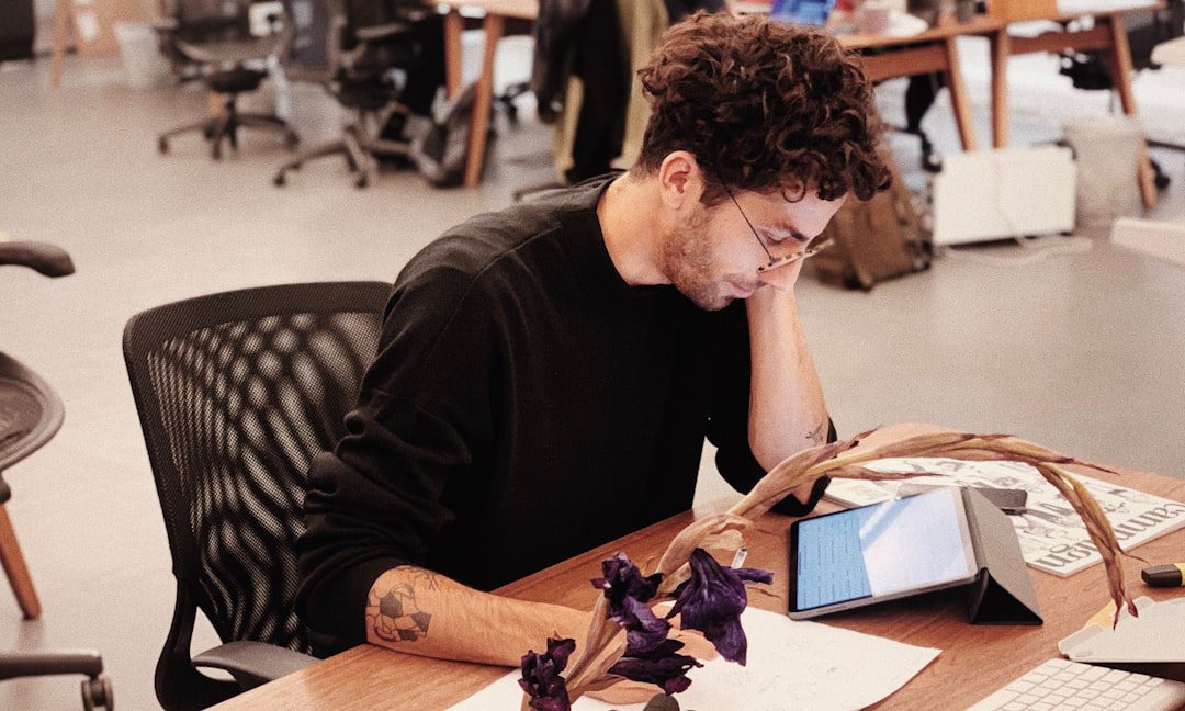 A homeowner with a concerned expression reviews papers and a calculator, representing the shock of understanding real estate marketing costs.