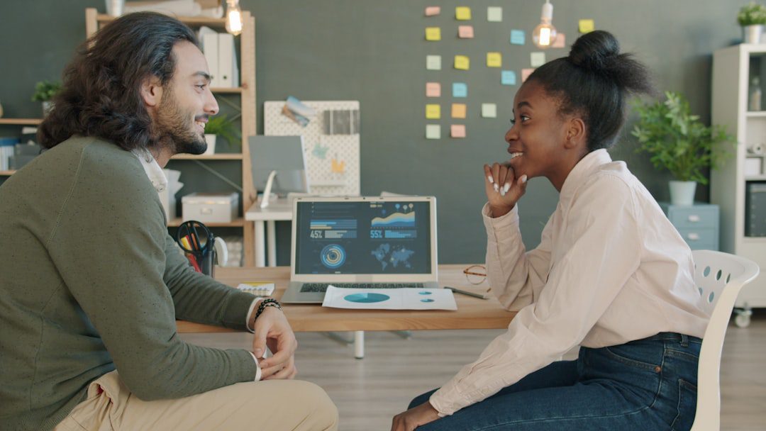 A professional and diverse real estate team collaborating around a conference table in a bright, modern office, showcasing the strategic teamwork needed for a successful home sale.