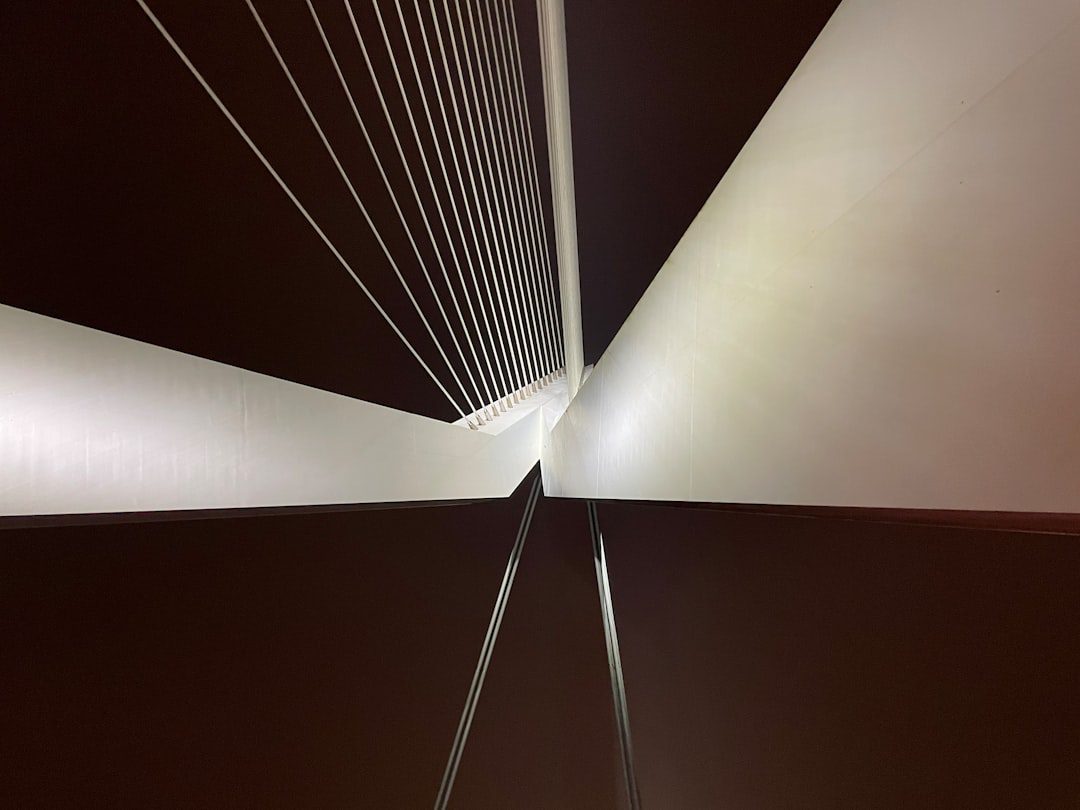 A sleek, minimalist photo of a modern bridge seamlessly connecting two land masses, symbolizing the smooth transition between selling and buying a home.