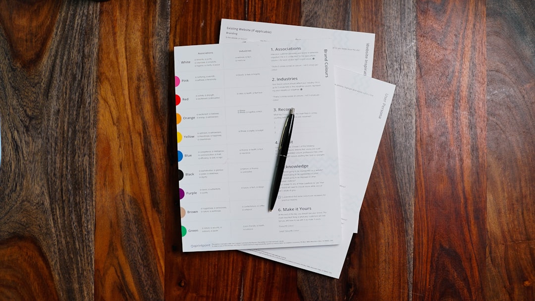 An organized flat lay of a notebook, a pen, a calculator, and house keys on a clean surface, representing a financial audit for a rental property.