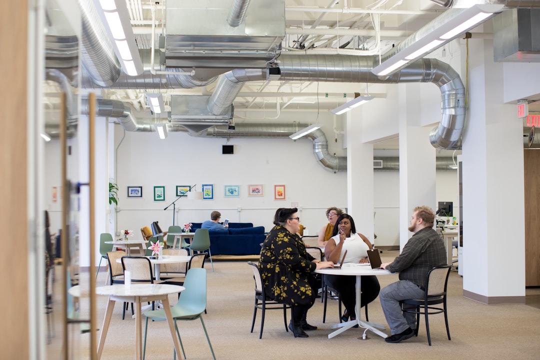 A team of real estate specialists collaborating around a table in a bright, modern office, illustrating a strategic and expert approach to managing a home sale.