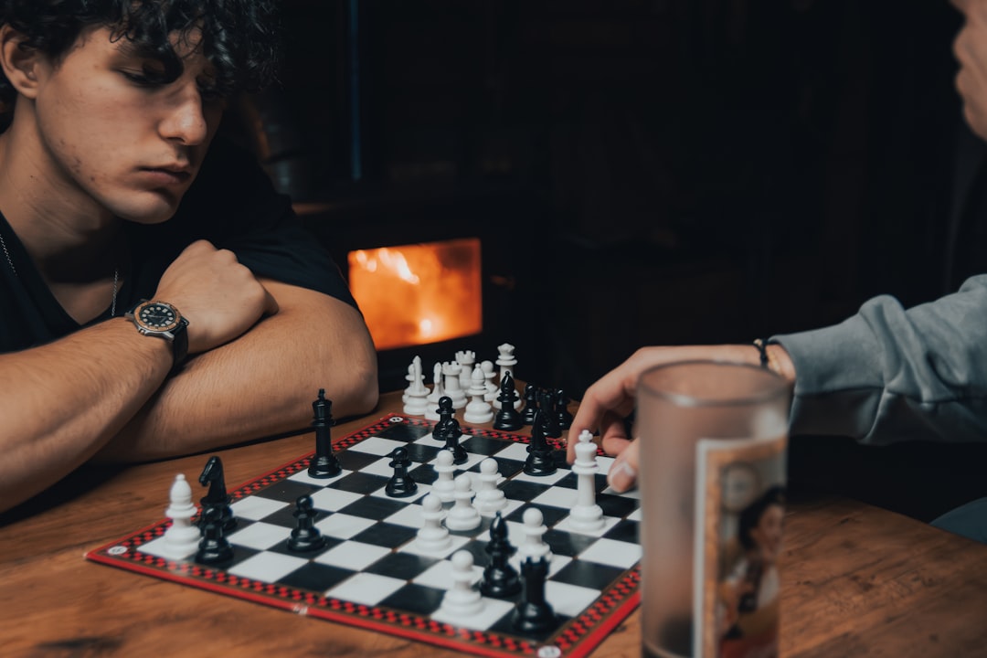 A close-up of a hand making a strategic move on a chess board, symbolizing the financial planning and risk mitigation of the PNNL relocation playbook.
