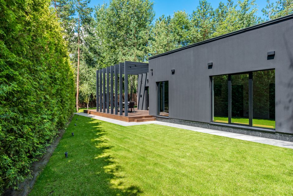 The front exterior of a beautiful, modern suburban home in Kennewick, WA, shown on a bright, sunny day, representing the ideal property.