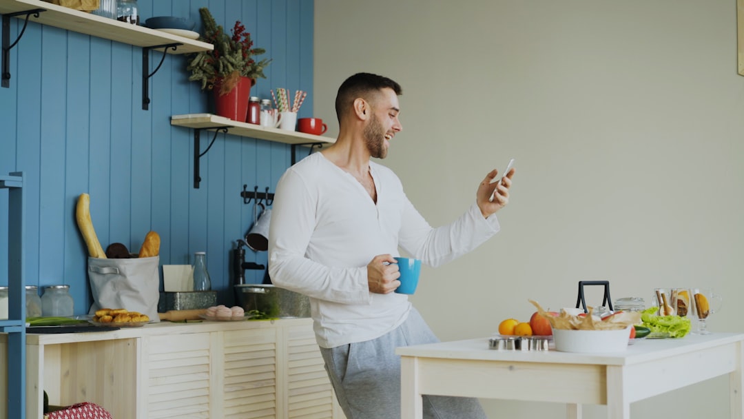 A person sits at a bright kitchen table with a laptop and documents, thoughtfully planning the next steps for an inherited property in Kennewick.