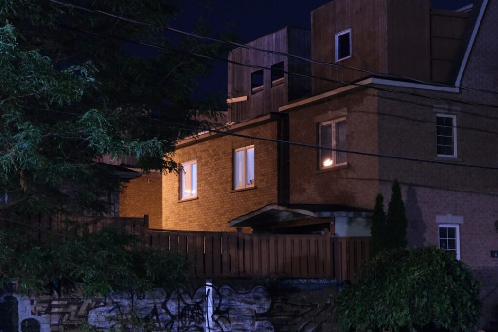 Split image or side-by-side view of two distinct modern homes, symbolizing the challenge of managing buying and selling si...
