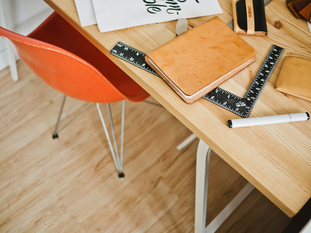 A close-up view of detailed architectural blueprints spread across a clean, modern desk, symbolizing the strategic and precise marketing plan for a top-dollar home sale.