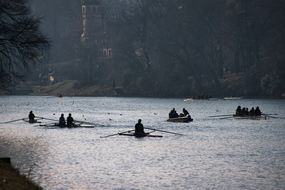 A competitive rowing team works in perfect unison, their oars hitting the water simultaneously, illustrating the power and efficiency of a specialized real estate team.