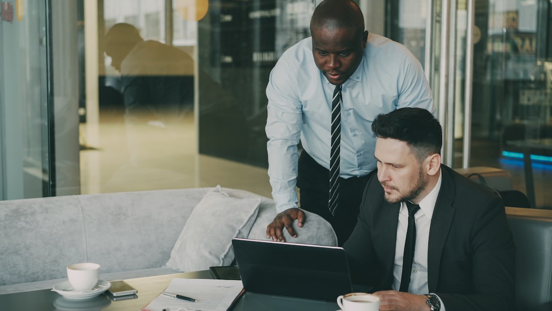 A diverse team of professionals actively collaborating around a modern conference table, symbolizing a powerful and systematic approach to selling a home.