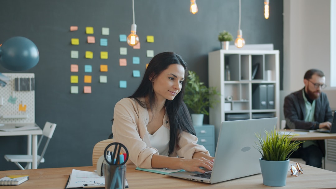 A diverse team of professionals collaborating effectively around a table in a bright, modern office, representing the specialist team model for real estate.