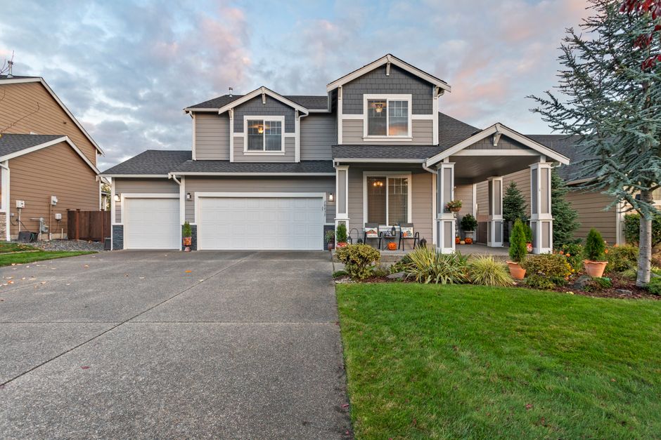 Exterior of a modern American suburban home with a manicured lawn and great curb appeal on a bright, sunny day.
