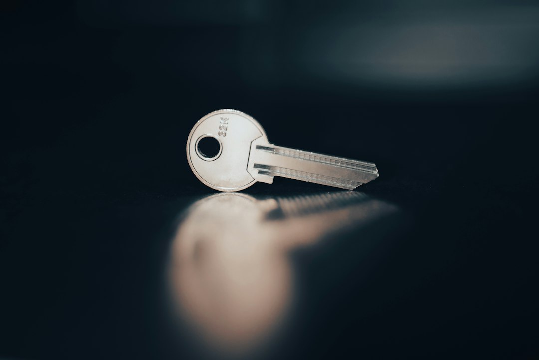 A set of house keys resting on a clean, modern wooden table, symbolizing a landlord's strategic decision to sell their rental property.