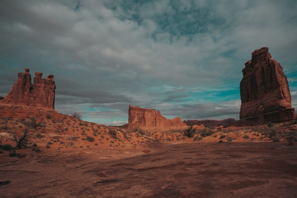 Single person stands on the edge of a vast, sunlit canyon, representing the significant exposure gap a solo agent faces in...